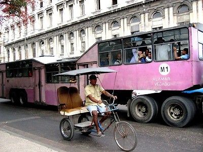 Photo. 2004. Cuba. Bicycle Taxi & Pink Bus